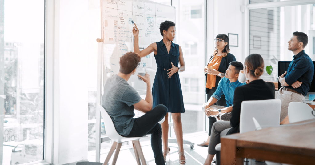 Team of coworkers meeting with a whiteboard