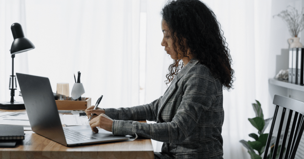 Person working and writing at their desk
