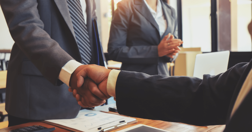People shaking hands at a meeting
