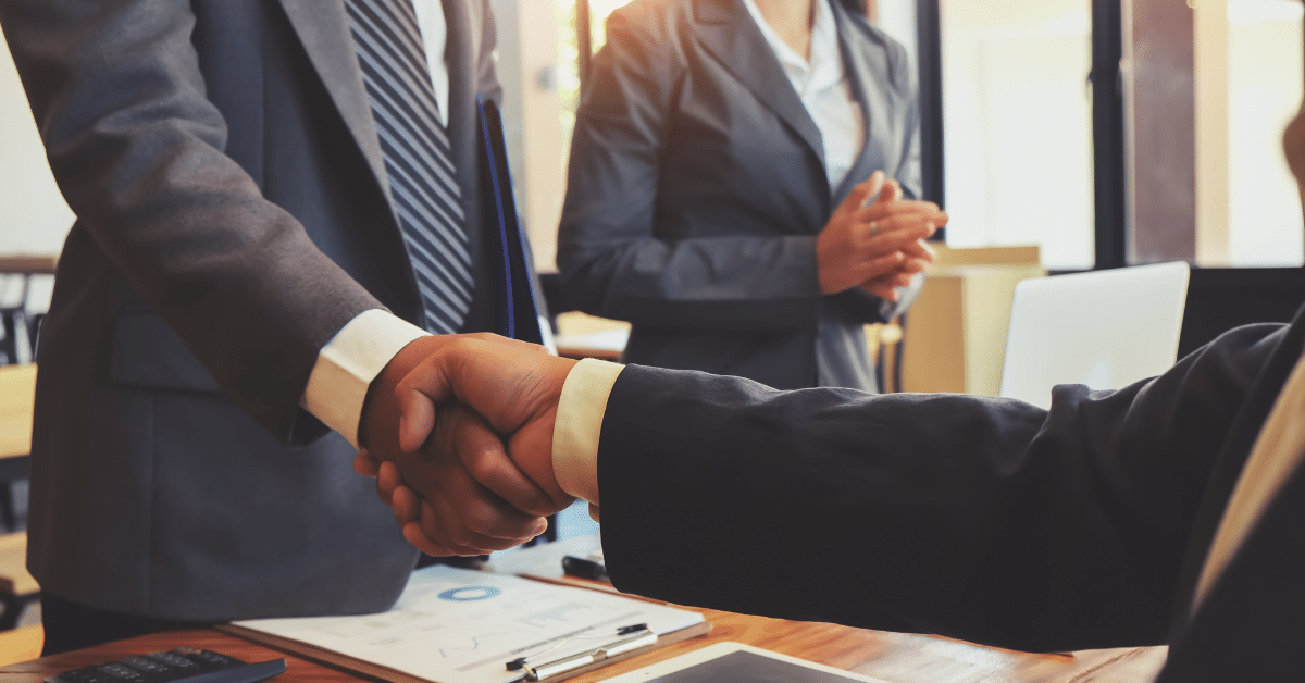 People shaking hands at a meeting