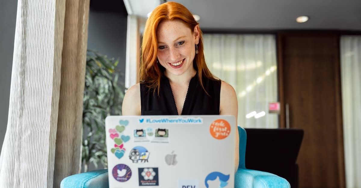 Person at their laptop working and smiling