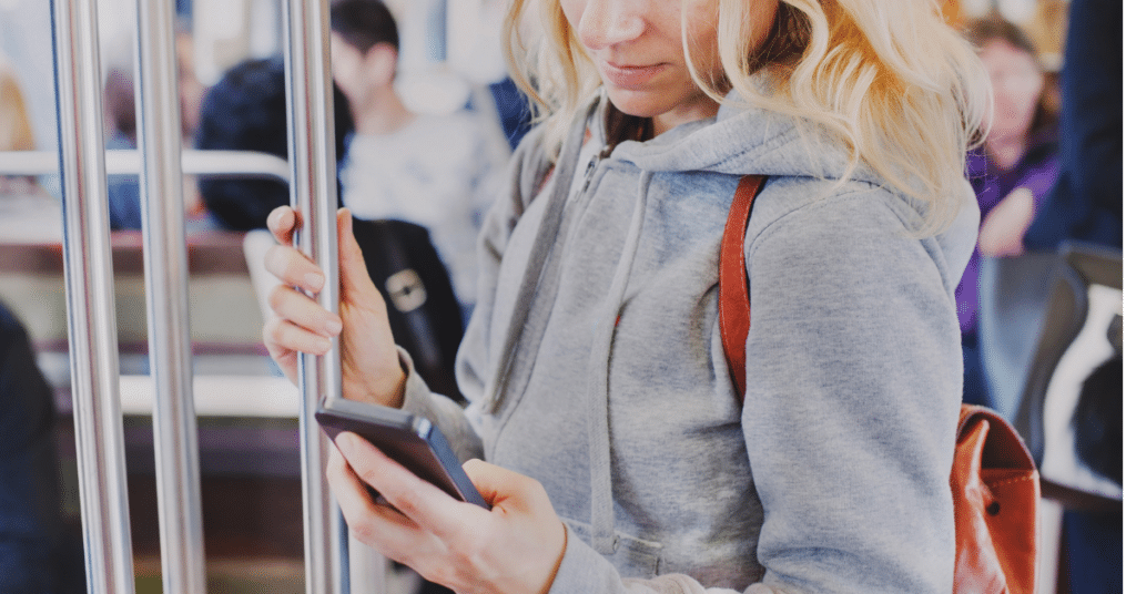 Person looking at phone on subway