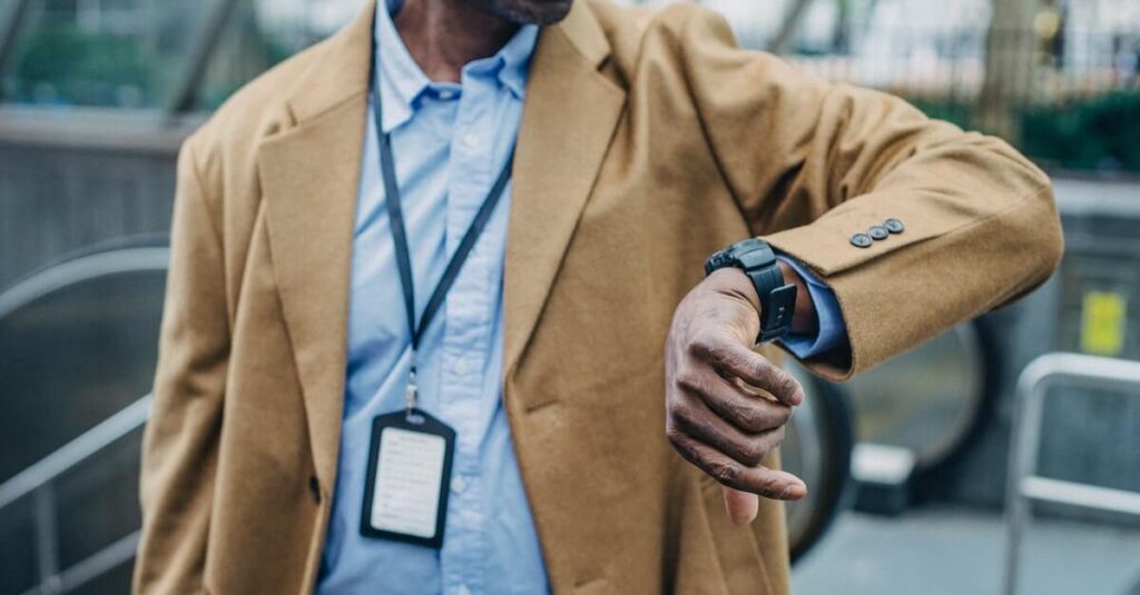 man looks at watch