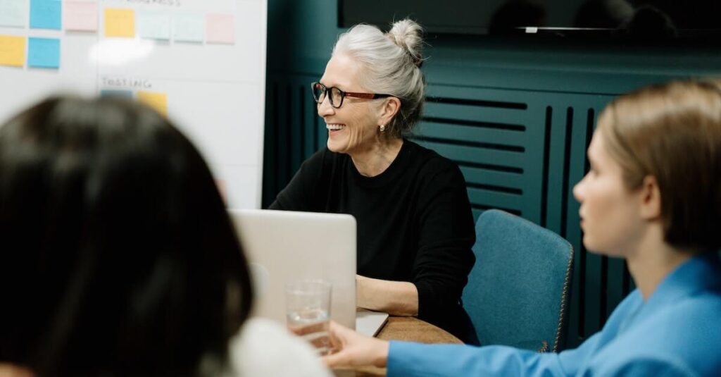 aged woman smiling office meeting 1