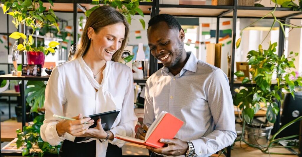 Two people talking reading a book together indoors